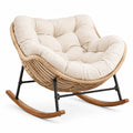 Poltrona a dondolo in rattan intrecciato e tessuto beige, 115 × 96 × 90 cm, con telaio nero e pattini marroni